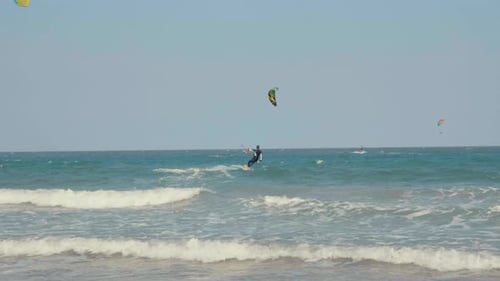 Kite Surfing or Windsurfing on Blue Sea Water
