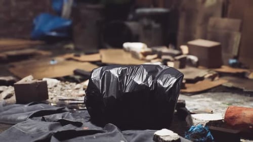 Uncollected Trash in a Dimly Lit Urban Alley Creating an Unsightly View