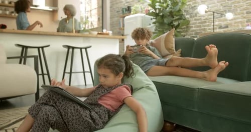 Children Using Technology at Home in Comfortable Setting