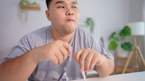 Young Man Enjoys Fresh Salad at Home