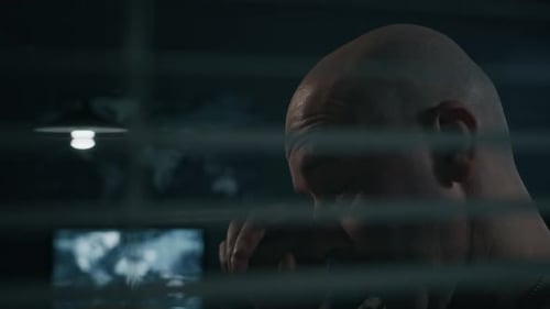 Man in Military Uniform Observing through Blinds in Command Center