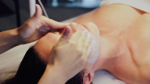 Woman Receives a Luxurious Facial Massage at Spa