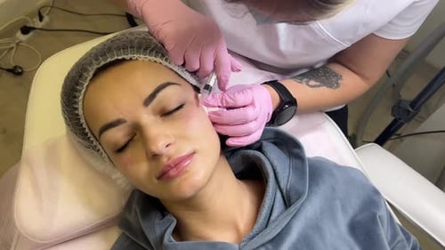 Adult Receiving Facial Injection in Clinical Setting