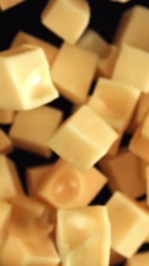 Maasdam Cheese Flies Up and Falls Down on a Black Background Filmed on a Highspeed Camera at 1000