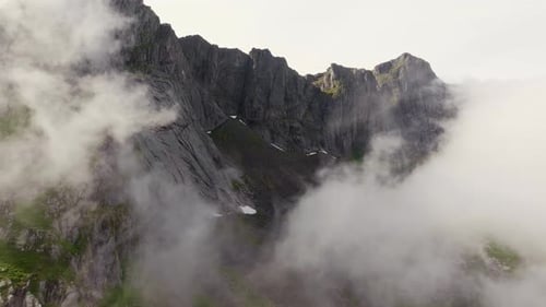 Aerial Adventure Drone Rising Above Clouds to Summit on Sunny Day