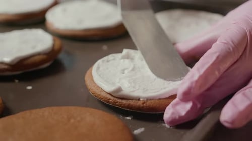 Spreading White Icing over Baked Cookie with Spatula