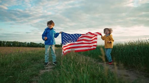 Children Holding American Flag in Rural Setting
