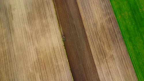 Aerial view of a tractor plowing a field