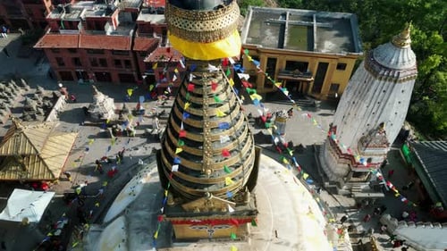 Aerial view of Swayambhunath temple, ancient buddhist shrine, with prayer flags moving in the wind,