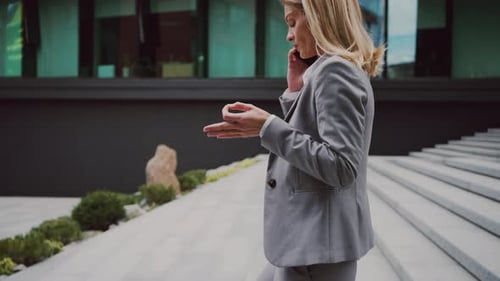 Professional Woman Talking on Phone Outside Office Building