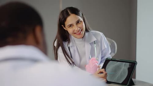 Doctor Consults with Patient Using Heart Model