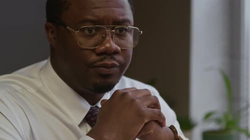 Woman Holding Failed Math Test while Talking to Principal in Office
