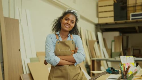 Portrait of professional carpenter or woodworker or charpentier woman stand with arm-crossed