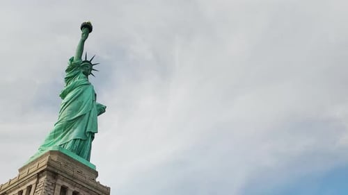Timelapse of the Statue of Liberty in Daylight with Clouds Drifting Above