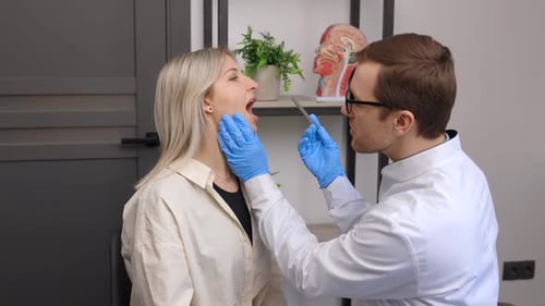 Doctor Examines Young Adult Patient in Medical Office