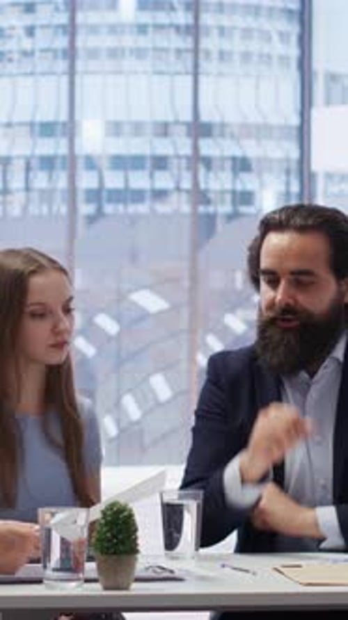 Vertical Video Consultant in Office Assisting Family Members in Setting Up Investment Accounts