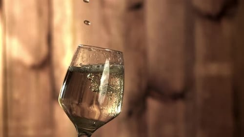 Wine Glass Fills with Sparkling Liquid in Slow Motion