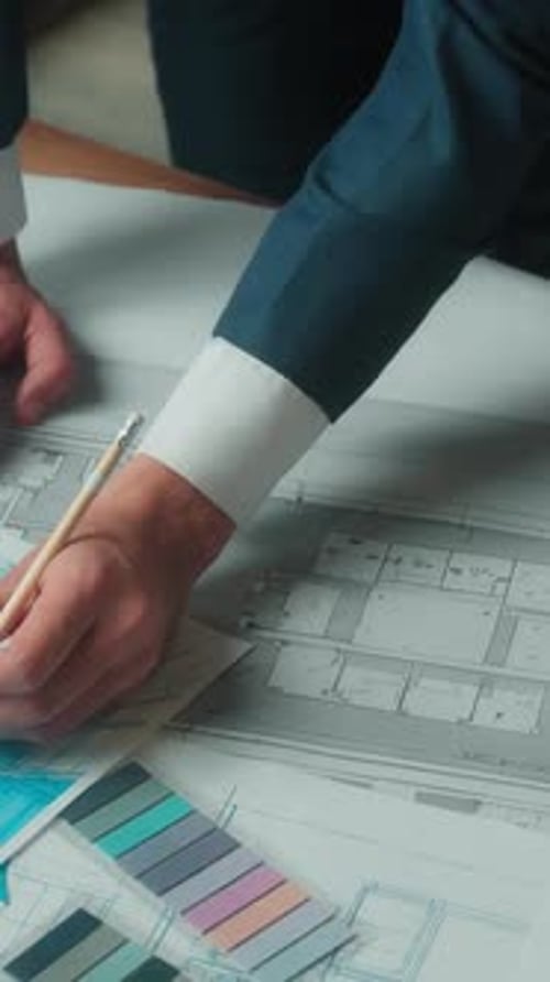 Architects Reviewing Plans Indoors