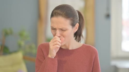 Woman Coughing Covering Mouth with Hands