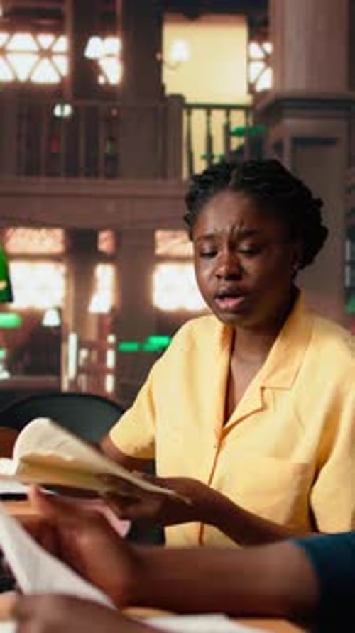 Woman Reading and Talking in Library