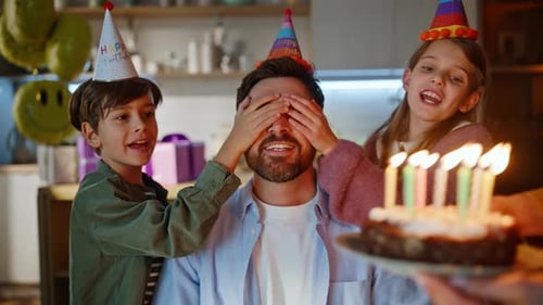 Happy Family Celebrates Birthday with Cake and Candles