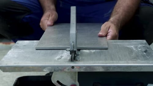 Man Cutting Tile on Wet Saw Machine