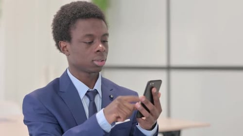 Excited Young Man Celebrates Using Mobile Phone