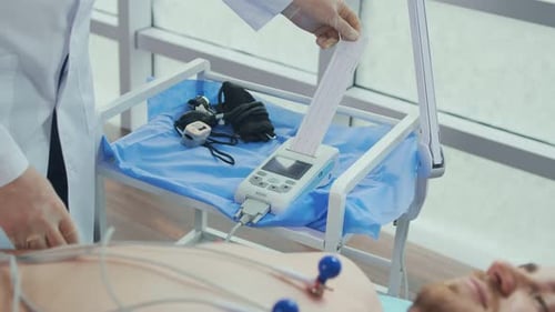 The Cardiologist Reads the ECG PrintoutThe Doctor Analyzes the Electrocardiogram