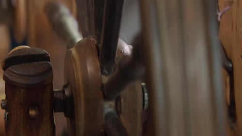 Craft: Close up spokes and hub of antique Nordic spinning wheel in use