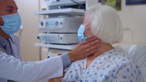 Doctor Examines Senior Patient in Hospital Room