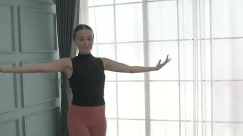 Friends practice ballet dance at studio.