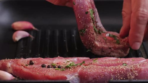 Cooking Raw Turkey Meat in Spices with Garlic and Greens on Grill Closeup Fry Chicken or Turkey