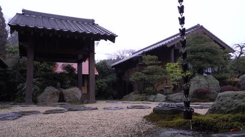 Beautifully Designed Japanese Garden On A Rainy Day - wide shot