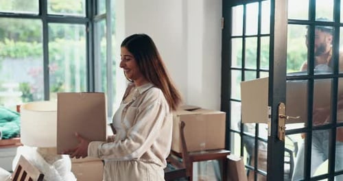 Young Couple Moving Boxes Into New Home
