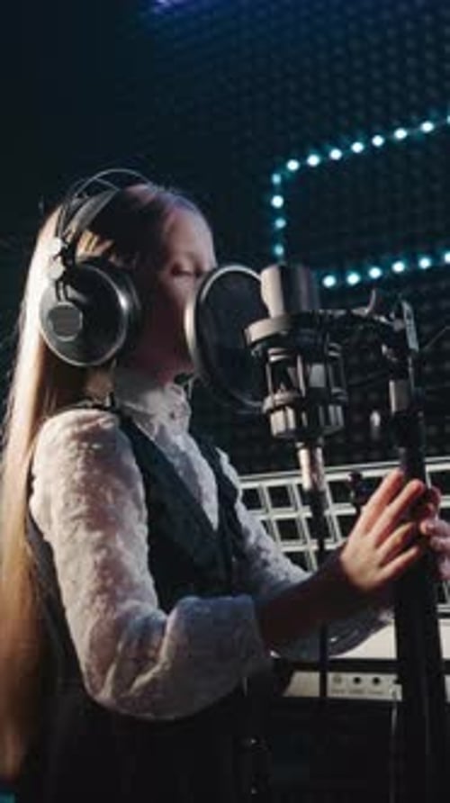 Child Clings to Microphone Stand Dancing