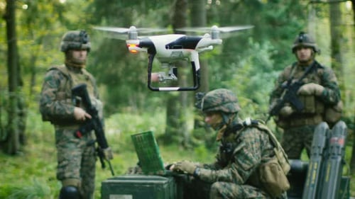In the Military Staging Base Army Engineer and Soldiers Fly Military Grade Industrial Drone for the
