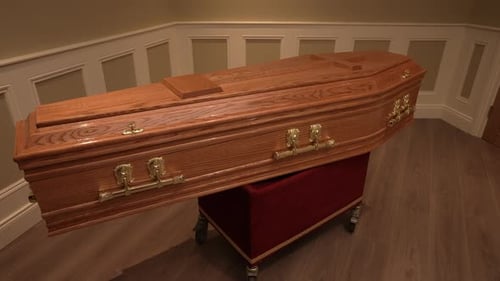 Wooden coffin, funeral and mourning concept. Indoors shot
