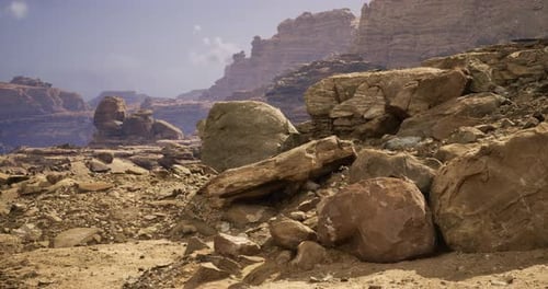 Rocky Desert Landscape with Layered Mountains in the Background During Daytime