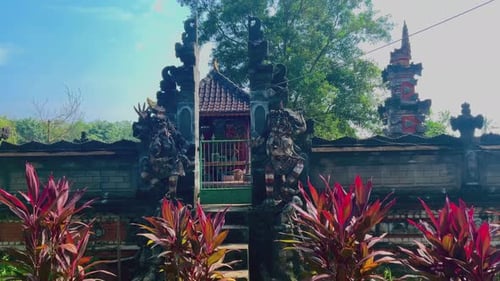 Ornate Wall with Statues and Temple in Tropics