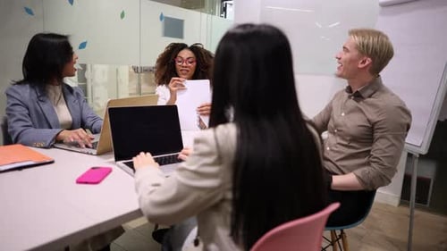 Multiracial coworkers collaborating on project in modern office