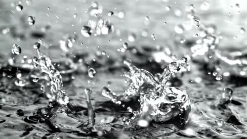 Raindrops Fall Into a Puddle Filmed on a Highspeed Camera at 1000 Fps