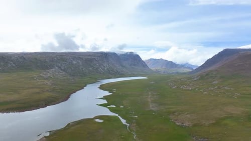 Alpine lake and valley surrounded by high mountains