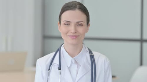 Smiling Woman Doctor in White Coat with Stethoscope