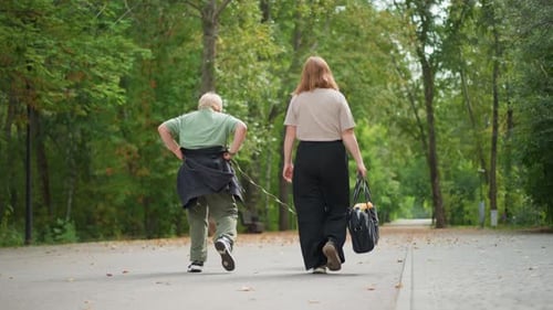 Woman And Young Boy Walking Along Wooded Trail Peacefully With Dog White Woman And Young Boy Move