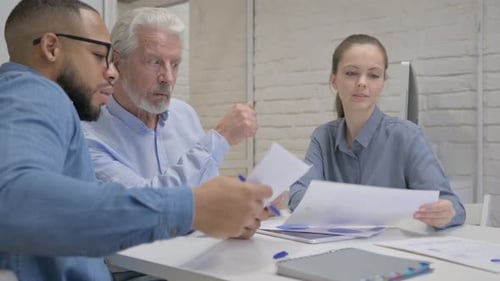 Mixed Race People Doing Paperwork in Office