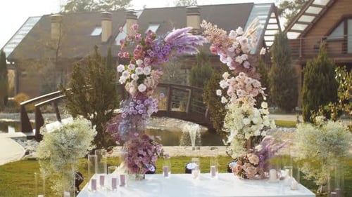 View of Wedding Floral Decorations of Flowers in Pastel Faded Colors Outside Wedding Ceremony in