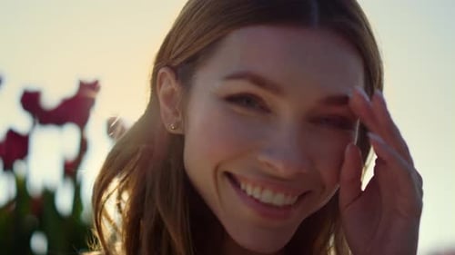 Smiling woman in sunlight