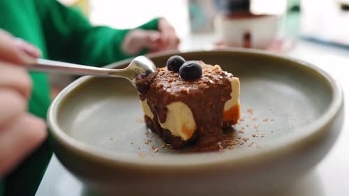Woman Eating Delicious Cake with Chocolate Glaze