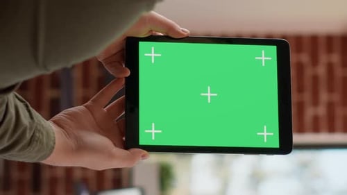 Vertical Video Office Worker Analyzing Greenscreen Template on Digital Tablet