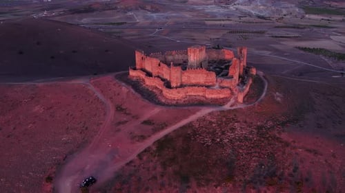 Aerial view of medieval castle ruins at sunrise, Almonacid de Toledo, Spain.